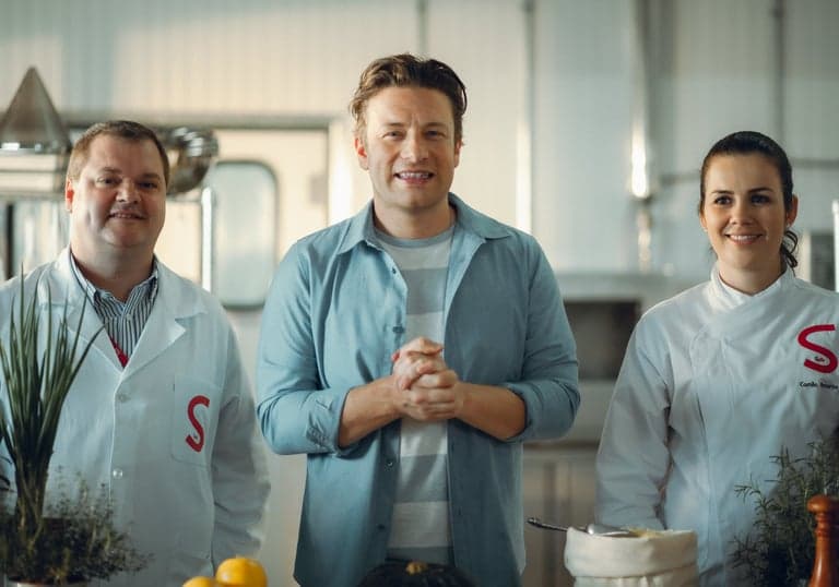 Food campaign film still: three chefs in a studio kitchen.